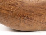 a close up of a wooden object on a white surface