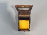 a small wooden box with a yellow light inside of it