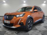 the orange suv is parked in a large room with a checkered floor