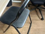a black chair sitting next to a wooden table