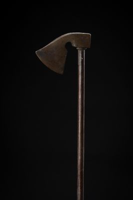 an old axe with a wooden handle on a black background