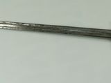 a close up of a knife on a table with a white background