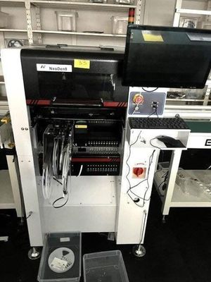 an image of a machine in a factory with a keyboard and monitor