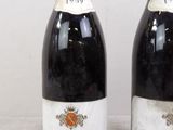 two bottles of wine sitting next to each other on a table