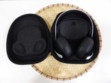 two black headphones sitting in a case on a table
