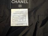 a black chanel jacket with a label on it