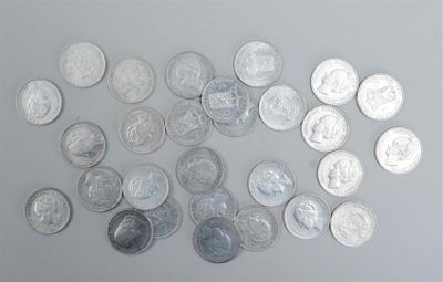 a lot of silver coins on a white surface