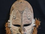an image of a wooden mask on a black background