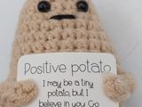 a small stuffed potato that has a sign on it