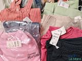 a lot of clothes that are on display in a store