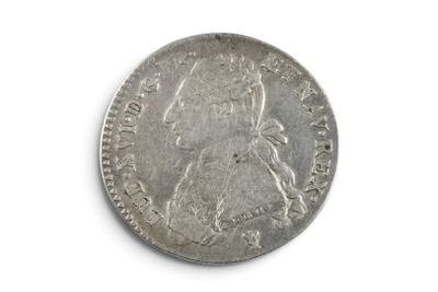 a close up of a silver coin on a white surface