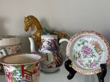 a glass shelf with a lot of different types of cups and saucers on it