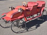 an old fashioned car that is sitting in the parking lot