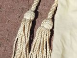 two tassels that are on the ground next to a bag