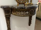 a clock sitting on top of a table in a room