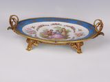 an ornate blue and gold plate with a woman and child on it