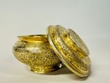 gold plated bowl with lid on a white background