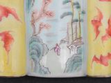 a vase with a painting on it sitting on a table
