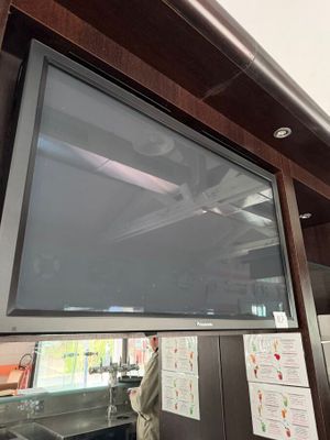 a flat screen tv mounted on the wall in the kitchen