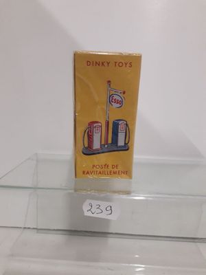 a box of dinky toys on display on a glass shelf