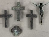 three crosses and a crucifix on the wall