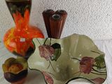 three vases and a bowl sitting on a table