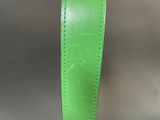 a close up of a green leather belt with a metal buckle