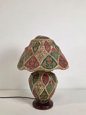 a close up of a lamp on a table with a white background
