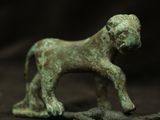 a statue of a dog that is standing on a rock