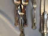 a lot of silver spoons and forks on the table