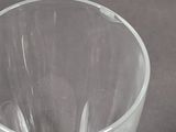 a clear glass cup sitting on a table