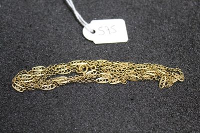 a close up of a gold chain with a tag on it