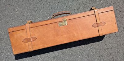 a brown suitcase that is sitting on the ground