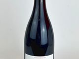 the bottle of red wine is sitting on the table