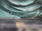 a close up of a bronze statue of a woman ' s head