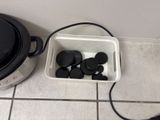 an image of a bowl of black buttons next to a crock pot