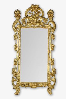 an ornate gold mirror with a bird and flower decoration