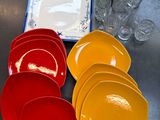 de nombreuses assiettes et tasses de différentes couleurs sur la table
