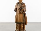 a wooden statue of a woman holding a baby in her arms