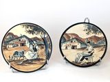 pair of vintage hand painted plates with asian scenes on them