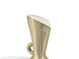 a gold cup that is sitting on a white surface