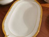 a wooden table topped with plates and bowls on top of it