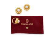 a pair of gold and pearl earrings and a red velvet pouch