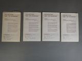 three papers are lined up on a gray surface
