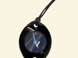 a picture of a black clock on a black cord