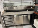 a kitchen that has a lot of stainless steel appliances in it