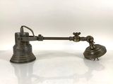 an antique brass desk lamp on a white surface
