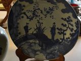 a plate with a picture of a man and a horse on it sitting on a table
