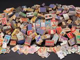 a pile of old matchboxes sitting on a table