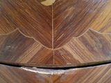 a wooden box with a leaf on it on a table